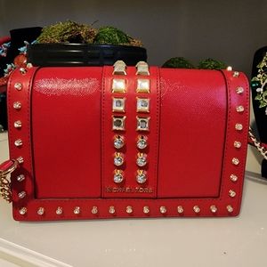 Red Michael Kors cross body bag with bling accent